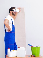 Wall Mural - Man with VR glasses gluing wallpaper