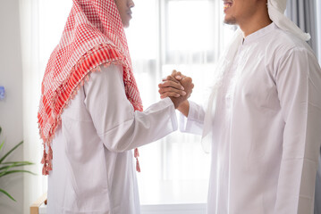 Wall Mural - portrait of business muslim partner shaking hand in the meeting