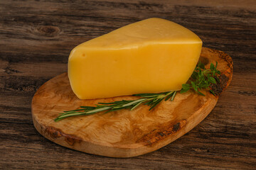 Hard cheese piece served rosemary