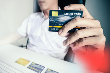 Poster - Man paying with credit cards on computer at home.