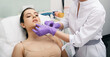 © Peakstock - Beautician doing filler injection in female lips for woman's lip augmentation. Injections for increase lips shape