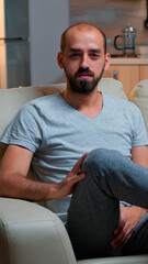Poster - Pov of freelancer man sitting on couch recording business interview during coronavirus quarantine. Caucasian male speaking about lifestyle while looking at camera late at night in kitchen