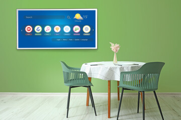 Poster - Modern TV set hanging on green wall in dining room