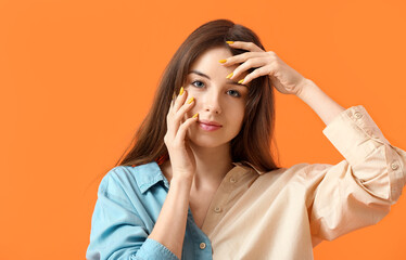 Wall Mural - Young woman with beautiful manicure on color background