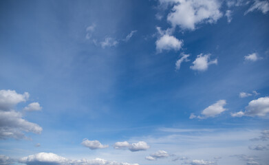 Wall Mural - horizontal color photography of beautiful sunny clear blue sky with many moving along. fluffy white 