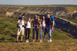 © Studio Romantic - A group of young hikers are walking on hill in nature.