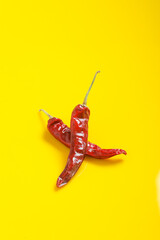 Dry Red chilli on yellow background.