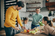 © Drazen - Happy family preparing healthy meal in the kitchen.