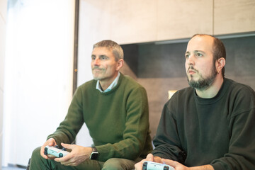 Sticker - Two men playing games at the gaming console