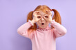 © alfa27 - Portrait of surprised cute little girl child standing isolated over purple background