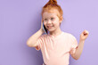© alfa27 - little redhead girl talking on phone indoors. concept of addiction of children and gadgets