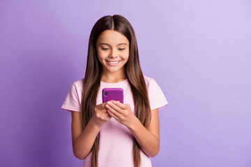 Wall Mural - Photo of optimistic nice brunette girl look telephone wear t-shirt isolated on pastel purple color background