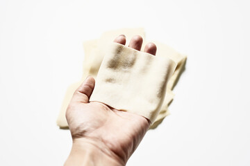 Sticker - Person holding a piece of yeast dough against a white background