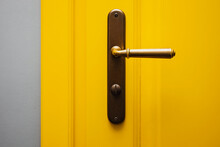 Close-up Shot Of Yellow Color Door With Vintage Door Knob.