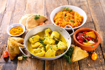 Wall Mural - assorted indian food - naan, curry chicken, dhal lentil and rice