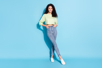 Poster - Photo of confident charming lady white smile look camera wear pullover jeans footwear isolated blue background