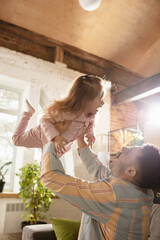 Wall Mural - Happy father and little cute daughter at home. Family time, togehterness, parenting and happy childhood concept. Weekend with sincere emotions.