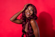 © deagreez - Photo of attractive nice afro american young woman look empty space hold hand empty space isolated on red color background
