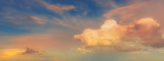 Wall Mural - beautiful evening cumulus clouds golden with pink blue sky