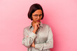 © Asier - Young mixed race woman isolated on pink background suspicious, uncertain, examining you.