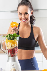 Wall Mural - Healthy diet and exercise performed by a fit young good looking woman