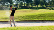 © freebird7977 - Asia Golfer man hitting out of a sand trap. The golf course is on the sand.  Hobby in holiday and vacations on club golf. Lifestyle and Sport Concept