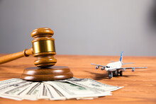 Court Gavel With Money And Airplane On The Table