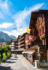 Wall Mural - Main street of Wengen with Swiss Flags in Switzerland