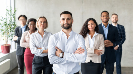 Wall Mural - Arab Businessman Standing In Front Of Multiracial Business Team Indoor