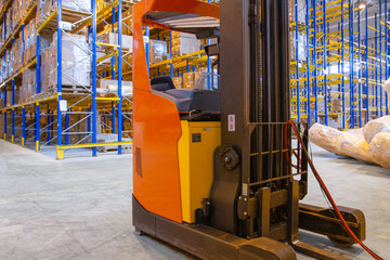 Wall Mural - Electrical forklift loader charging in the warehouse. Pallet stacker truck equipment inside of a modern warehouse storage