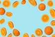 Frame of sliced fresh orange isolated on light blue background.