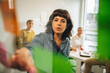 © Jacob Lund - Woman discussing new ideas with team using sticky notes