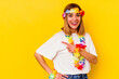 © Asier - Young caucasian woman celebrating a hawaiian party isolated on yellow background smiling and pointing aside, showing something at blank space.
