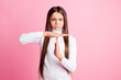 © deagreez - Photo of unhappy serious young girl wear white jumper showing time our gesture isolated pink color background