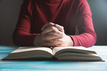 Wall Mural - young guy praying on a book