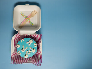 a small cake in a paper box with a fork and a candle, a holiday for two, a copy of the space