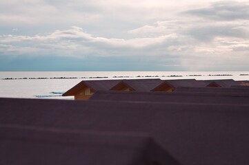 Wall Mural - Colorful beach cabins in front of the Adriatic Sea at sunrise (Pesaro, Italy, Europe)