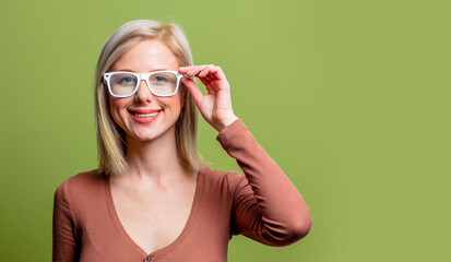 Wall Mural - Beautiful blonde girl in a glasses and brown blouse