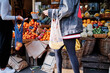 © Angel Santana - Women with eco friendly bags buying fruits on street market
