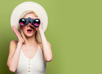 Canvas Print - Beautiful blonde girl in a white hat and dress with binoculars