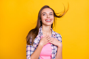 Sticker - Portrait of lovely cheerful girl enjoying good mood wind bowing air isolated over bright yellow color background