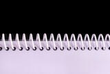 Fototapeta Dziecięca - Notebook spiral spines on black background