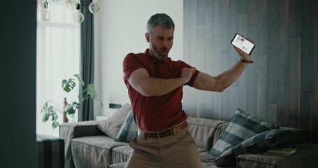Wall Mural - Joyful caucasian sexy handsome funny bearded an celebrating success in business, job promotion or high salary, dancing around house.