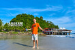 happy tourist guy on the central beach in Langkawi tropical island