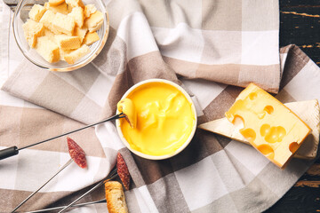 Cheese fondue and different snacks on table