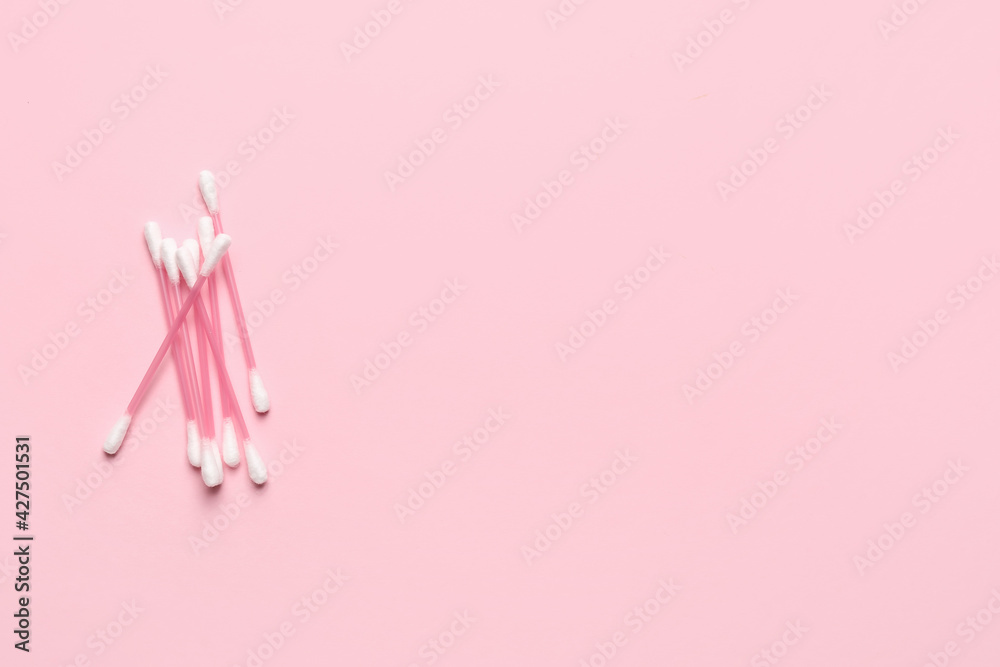Cotton swabs on color background