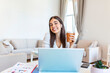 © Graphicroyalty - Excited young woman looking at camera, holding funny conversation with colleagues online, webcam view. Head shot of young woman with headphones laughing, having fun from home office.
