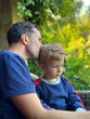 © Marina - Father and son on the background of nature. Father's day