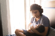 © Antonio Tanaka - young happy hispanic father hugging and holding his newborn baby
