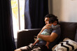 © Antonio Tanaka - young happy hispanic father hugging and holding his newborn baby